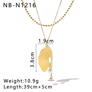 Detail of double-layer gold necklace with shell texture pendant and pearl drops