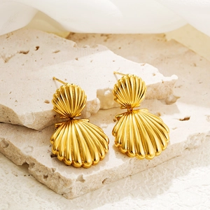 Detailed macro view showing the metallic texture of gold double shell earrings