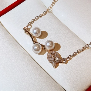 Macro shot of rose pearl pendant necklace with zircons on a white jewelry display box