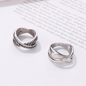 Macro shot of silver woven rings with heart beads and twisted sparkling stones