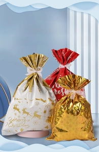 Detailed view of festive Christmas drawstring gift bags with ribbons and star patterns
