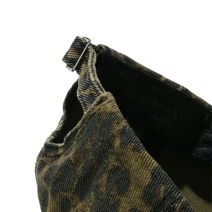 Macro shot of the adjustable metal buckle and leopard pattern cotton fabric on baseball cap