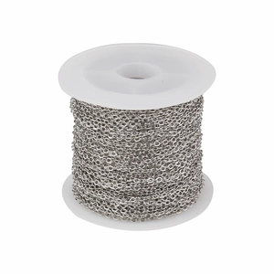 Detailed close-up of a 10-yard silver-plated copper cable chain on a white plastic spool