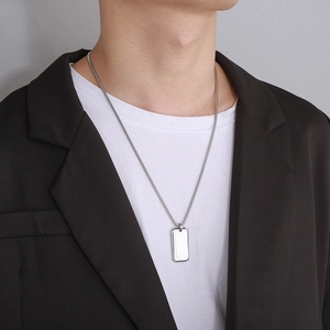 Male model wearing a polished silver stainless steel rectangular dog tag pendant necklace