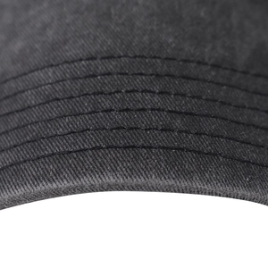 Close-up of the stitching details and washed cotton texture on a black baseball cap