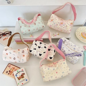 Detailed view of assorted cute cartoon quilted handbags with elegant lace trim borders