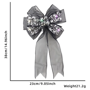 Close-up of black gauze Halloween bow with skull patterns and integrated LED lights