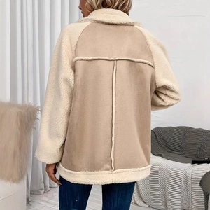 Rear view of loose beige shearling jacket featuring faux suede stitching and warm lining