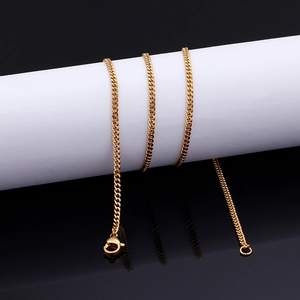 Detail of golden Cuban link necklace with lobster clasp on a white display stand