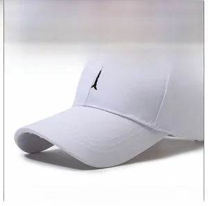 Detail of white cotton baseball cap featuring black tree embroidery and reinforced brim