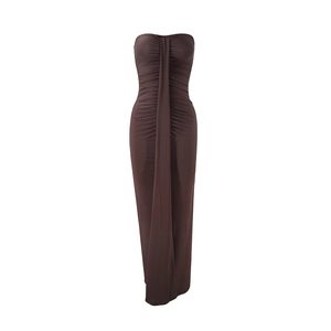 Detail of ruched fabric on a brown strapless bodycon maxi dress with center drape