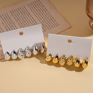 Close-up of a 6-piece water drop earring set in gold and silver with textured finishes