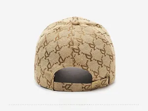 Close-up of beige jacquard baseball cap back with adjustable strap and metal buckle detail