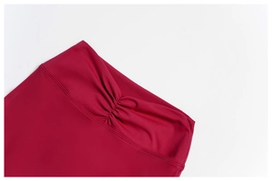 Detail of high waist wine red flared pants featuring scrunch butt lifting texture