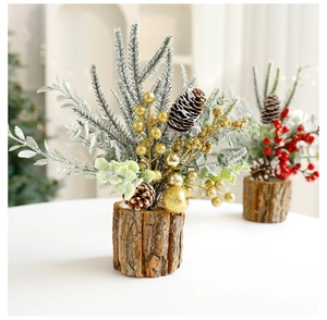Close-up of artificial mini Christmas tree with snow, pine cones and red gold berries