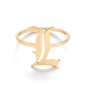 Macro detail of gothic letter L engraving on a vintage gold stainless steel ring
