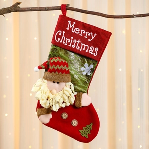 Close-up of linen Christmas stocking with 3D Santa Claus and Merry Christmas embroidery