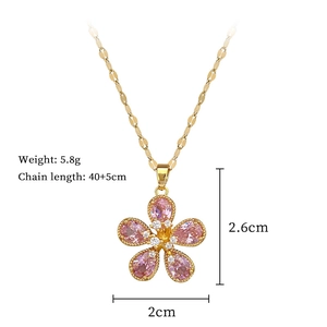 Detail view of pink crystal flower pendant with gold chain and size measurements