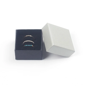 Three-piece gold ring set with blue and white crystals in a premium gift box