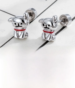 Macro shot of silver bulldog stud earring with red collar detail and screw back