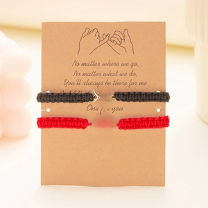 Detail of hand-woven spider web friendship bracelets set on a sentimental gift card