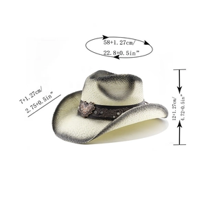 Detail view of western cowboy straw hat showing heart metal buckle and carving