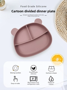 Detail of pink silicone bear-shaped baby plate with divided sections and suction cup base