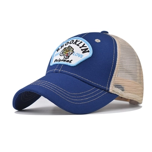 Detail view of Brooklyn Tiger embroidery and breathable mesh on a navy trucker hat