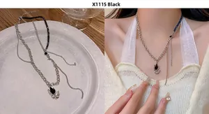 Detail of asymmetric tulip necklace with black enamel, silver chain and bead accents