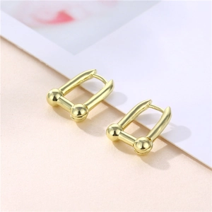Minimalist golden U-shaped link earrings with metallic ball detail in French style
