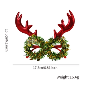 Christmas reindeer antler glasses with green glitter wreath and Merry Christmas sign