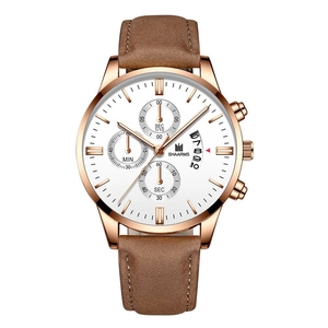 Close-up of brown leather strap and rose gold case chronograph watch with white dial