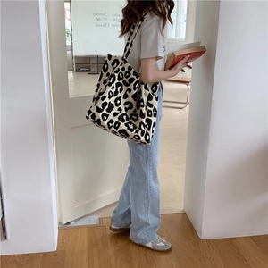 Canvas tote bag with black and white leopard print shown on a model for daily use