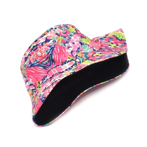 Detail of reversible bucket hat with colorful floral print and solid black inner lining