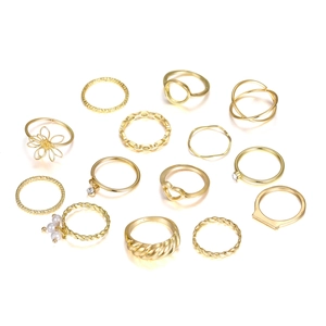Detail view of 13-piece gold ring set featuring heart, leaf, and pearl designs on white background
