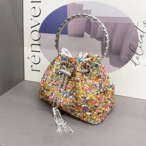 Detailed shot of bucket bag with colorful crystals and silver ring handle texture