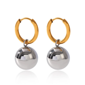 Detailed view of polished gold hoops with silver spherical pendants in mirror finish