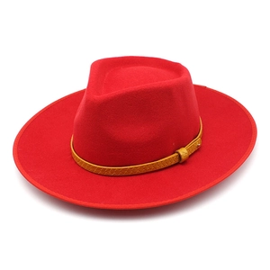 Classic red wool fedora hat with a stylish yellow braided leather band on white background