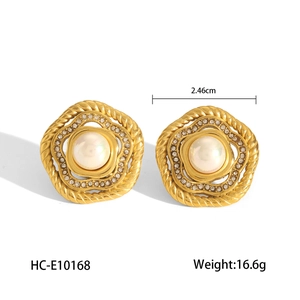 Detail of 18K gold earrings with round white pearl and sparkling diamond halo