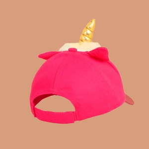 Detail of pink unicorn baseball cap showing golden horn and adjustable velcro strap