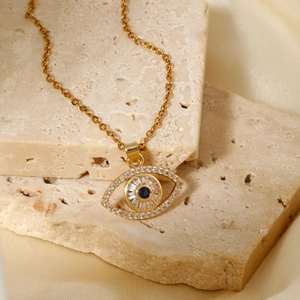 Elegant gold evil eye pendant necklace with blue stones on minimalist stone base