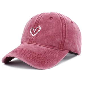Detailed embroidery of a white hand-drawn heart on washed burgundy cotton baseball cap