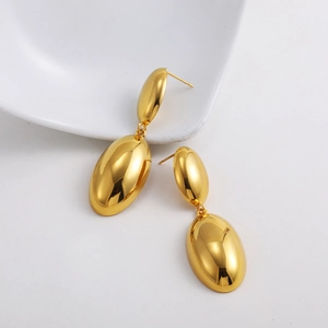 Close-up of polished 18K gold double oval drop earrings with mirror-like finish