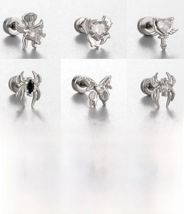Macro view of assorted silver titanium steel earrings with hearts and butterfly motifs