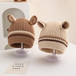 Cute striped knitted baby hats with small ears in brown and cream on display stands