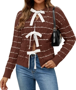 Close-up of white bow tie closures on dark brown striped knit cardigan for women