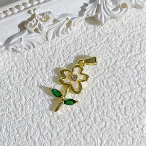 Elegant gold daisy pendant with white petals and purple zircon on a vintage white background