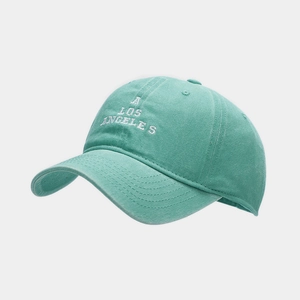 Close-up of white A LOS ANGELES embroidery on mint green washed cotton baseball cap