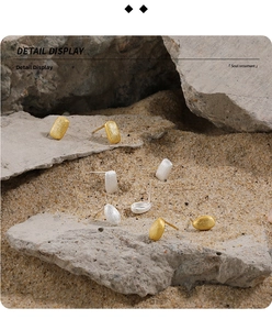 Close-up of geometric S925 sterling silver stud earrings with brushed matte finish
