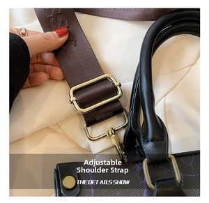 Detail show of adjustable brown woven shoulder strap with gold-tone hardware on tote bag